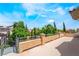 Balcony with a view of the blue sky, mature trees, and nearby houses providing a tranquil outdoor space at 5186 San Milano Ave, Las Vegas, NV 89141