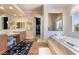 Bright bathroom with a soaking tub, double vanity, and access to a walk-in closet at 5186 San Milano Ave, Las Vegas, NV 89141