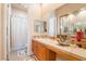 Bright bathroom featuring a double sink vanity with honey oak cabinets, and a shower with a white curtain at 5186 San Milano Ave, Las Vegas, NV 89141