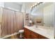 Bathroom boasts a single sink vanity, a shower with a curtain, and neutral finishes at 5186 San Milano Ave, Las Vegas, NV 89141