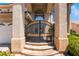 A grand entryway with ornate iron gates and manicured landscaping welcomes you to this elegant home at 5186 San Milano Ave, Las Vegas, NV 89141