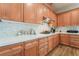 Kitchen with wooden cabinetry, white countertops, tiled backsplash and stainless steel appliances at 5186 San Milano Ave, Las Vegas, NV 89141