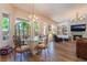 Living Room showcases a glass dining table, fireplace, chandelier, and large windows at 5186 San Milano Ave, Las Vegas, NV 89141