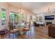 Living Room showcases a glass dining table, fireplace, chandelier, and large windows at 5186 San Milano Ave, Las Vegas, NV 89141