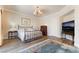 This main bedroom features wood floors, a vintage chandelier, and stylish furniture at 5186 San Milano Ave, Las Vegas, NV 89141