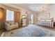 Spacious bedroom featuring a cozy sitting area and a decorative chandelier at 5186 San Milano Ave, Las Vegas, NV 89141