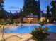 Relaxing outdoor pool and spa area featuring manicured landscaping and ambient lighting at 5186 San Milano Ave, Las Vegas, NV 89141