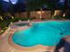Beautiful pool and spa with elegant lighting, providing a relaxing ambiance for evening enjoyment at 5186 San Milano Ave, Las Vegas, NV 89141