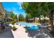 Inviting backyard oasis with a sparkling pool, spa, mature trees, and ample lounge space at 5186 San Milano Ave, Las Vegas, NV 89141
