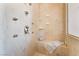 This shower includes various shower heads, a tile bench, and plenty of shelving at 5186 San Milano Ave, Las Vegas, NV 89141