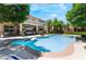 Backyard featuring a sparkling swimming pool and lush landscaping, creating a private oasis at 5186 San Milano Ave, Las Vegas, NV 89141