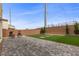 Backyard featuring low maintenance lawn, privacy wall, and hardscaped patio at 5255 Peak Rock Ct, Las Vegas, NV 89141
