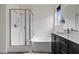Modern bathroom features a shower, soaking tub, and dark-stained vanity with solid surface countertops at 5255 Peak Rock Ct, Las Vegas, NV 89141