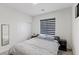 Cozy bedroom features a gray color palette, window with blinds, and a mirrored closet at 5255 Peak Rock Ct, Las Vegas, NV 89141