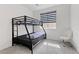 Bedroom with a bunk bed, chair, and carpeted floors at 5255 Peak Rock Ct, Las Vegas, NV 89141