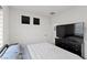 Bright bedroom boasts a large TV, dresser, and stylish window coverings at 5255 Peak Rock Ct, Las Vegas, NV 89141