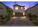 Charming two-story home showcases a well-maintained yard, brick driveway, and a two-car garage at 5255 Peak Rock Ct, Las Vegas, NV 89141