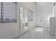 Bright hallway featuring sleek tile flooring and light-filled windows at 5255 Peak Rock Ct, Las Vegas, NV 89141
