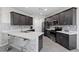 Modern kitchen features stainless steel appliances, mosaic backsplash, and quartz countertops with a breakfast bar at 5255 Peak Rock Ct, Las Vegas, NV 89141