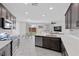 Bright open kitchen boasts stainless appliances, mosaic backsplash, and connects to dining and living areas at 5255 Peak Rock Ct, Las Vegas, NV 89141