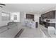 Open-concept living space with kitchen island, stainless appliances, and lots of light at 5255 Peak Rock Ct, Las Vegas, NV 89141
