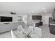 Open floor plan with large television, dining area, living area, and modern kitchen at 5255 Peak Rock Ct, Las Vegas, NV 89141