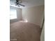 Bedroom with a ceiling fan, window, neutral-colored walls, and carpeted flooring at 555 E Silverado Ranch Blvd # 1123, Las Vegas, NV 89183