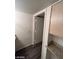 Hallway with wood-style flooring and a granite countertop next to a doorway and beige walls at 555 E Silverado Ranch Blvd # 1123, Las Vegas, NV 89183