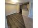 Open layout featuring new laminate floors flowing into carpeted living room, adjacent to the kitchen at 555 E Silverado Ranch Blvd # 1123, Las Vegas, NV 89183