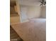 A living room with an outdated carpet, ceiling fan, and glass sliding door at 555 E Silverado Ranch Blvd # 1123, Las Vegas, NV 89183