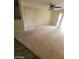 A spacious living room with ceiling fan and a sliding glass door leading to the outside at 555 E Silverado Ranch Blvd # 1123, Las Vegas, NV 89183