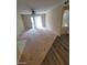 Living room with transition from carpet to wood-style flooring and view to an adjacent room at 555 E Silverado Ranch Blvd # 1123, Las Vegas, NV 89183