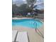 Community pool area with lounge chairs and tables for relaxing at 555 E Silverado Ranch Blvd # 1123, Las Vegas, NV 89183