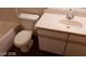 Bathroom featuring a white toilet and vanity with sink and storage at 5750 E Hacienda Ave # 202, Las Vegas, NV 89122