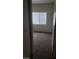 View of a carpeted bedroom with a window covered by blinds at 5750 E Hacienda Ave # 202, Las Vegas, NV 89122