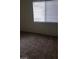 Bedroom featuring neutral walls and carpeting, along with a window for natural light at 5750 E Hacienda Ave # 202, Las Vegas, NV 89122
