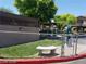 Community dog park with fence, bench, and pet waste station at 5750 E Hacienda Ave # 202, Las Vegas, NV 89122