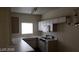 Well-lit kitchen featuring white appliances, ample counter space, and a window offering natural light at 5750 E Hacienda Ave # 202, Las Vegas, NV 89122