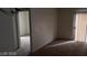 Living room featuring neutral walls and access to both an adjacent room and a sliding glass door at 5750 E Hacienda Ave # 202, Las Vegas, NV 89122