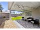 Cozy backyard patio with string lights, furniture, and a turfed area for recreation at 6017 Montecito Way, Las Vegas, NV 89108