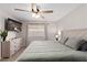 Bright bedroom featuring a ceiling fan, a flat screen TV, and a large bed at 6017 Montecito Way, Las Vegas, NV 89108
