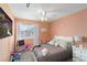 Colorful bedroom features a ceiling fan, a window, and plenty of natural light at 6017 Montecito Way, Las Vegas, NV 89108
