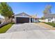 Charming single-story home with a well-manicured lawn and a paved driveway leading to a two-car garage at 6017 Montecito Way, Las Vegas, NV 89108