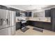 Modern kitchen with stainless steel appliances, dark cabinetry, wood countertops, and a subway tile backsplash at 6017 Montecito Way, Las Vegas, NV 89108