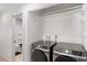 Laundry room with two Samsung washing machines and access to the bathroom at 6017 Montecito Way, Las Vegas, NV 89108