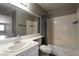 Bathroom featuring a large mirror, vanity with sink, toilet, and a bathtub with shower at 6873 Tamarus St # 201, Las Vegas, NV 89119