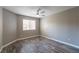 Neutral bedroom with wood-look floors, a ceiling fan and a window with blinds at 6873 Tamarus St # 201, Las Vegas, NV 89119