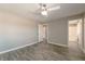 Bedroom featuring ensuite bath, wood-look floors, neutral paint, and a modern ceiling fan at 6873 Tamarus St # 201, Las Vegas, NV 89119