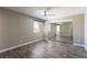 Bedroom featuring mirrored closet doors, wood-look floors, neutral paint, and a modern ceiling fan at 6873 Tamarus St # 201, Las Vegas, NV 89119