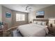 This bedroom features vinyl floors, a ceiling fan, and a view of the window at 6873 Tamarus St # 201, Las Vegas, NV 89119